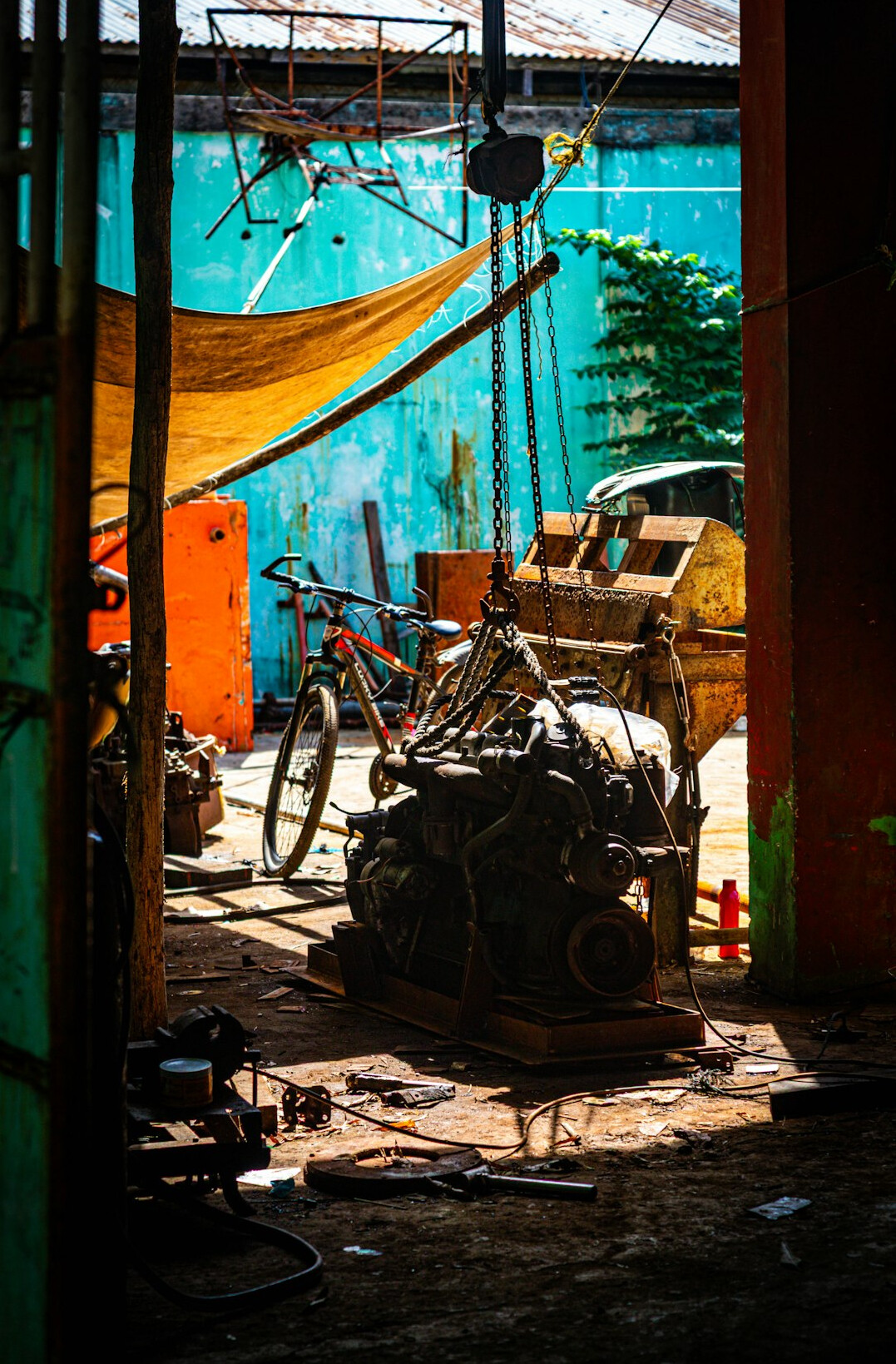 Car lifted in a garage workshop with tools around